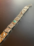 Solid Sterling Silver Link Bracelet with Kingman Turquoise center stone.  Each link has a symbol soldered to the tile
